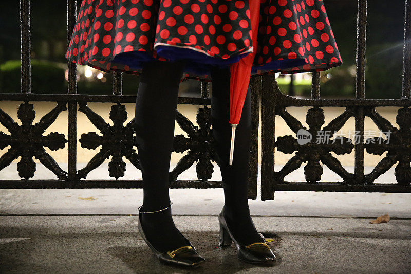 Red and Black Polkadot skirt, Woman Holding Umbrella, Gothic Fence